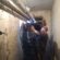 Працівники ПП “Вікторія – М” проводять теплоізоляцію труб у підвалі
